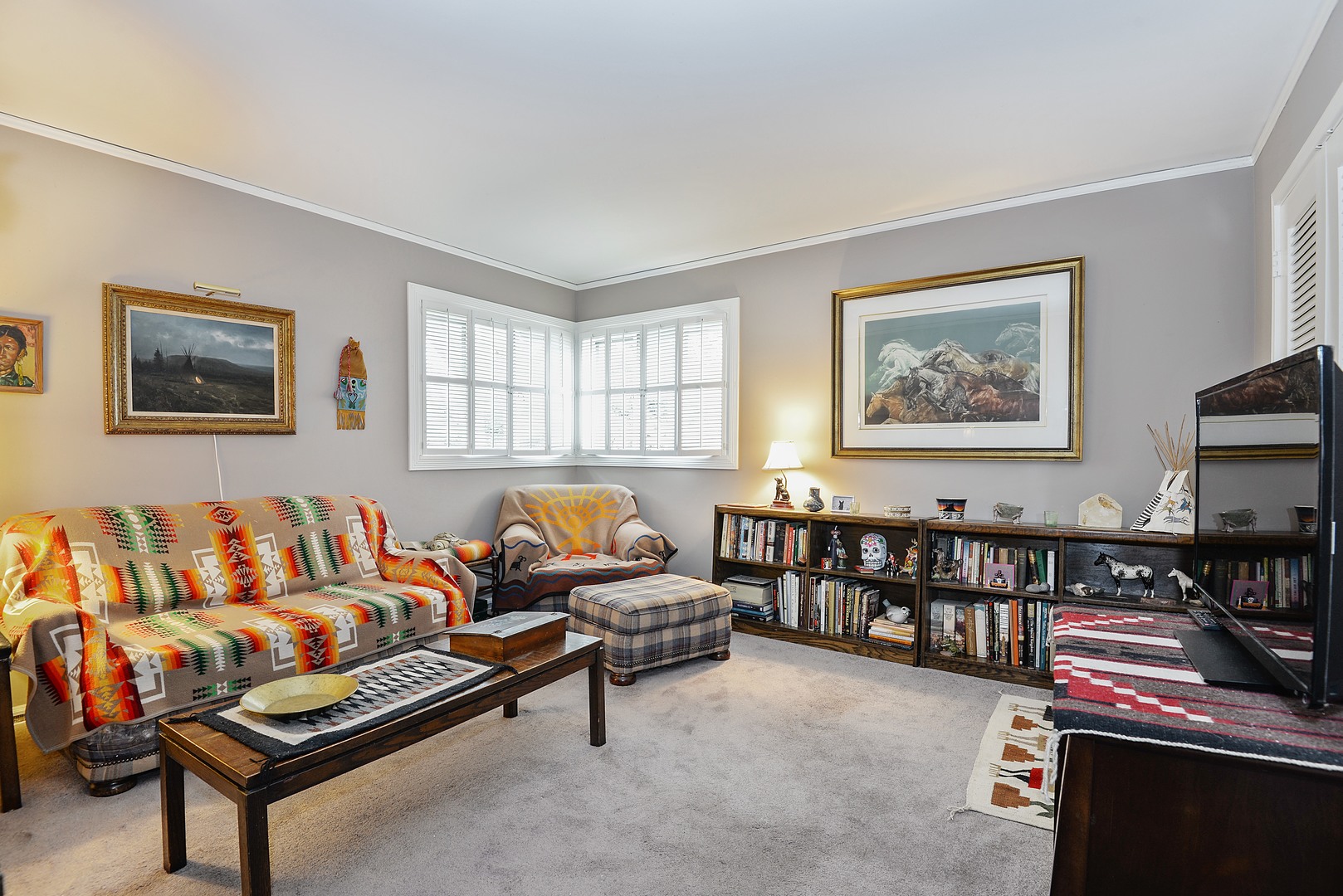 3225 Illinois Road Wilmette, IL 60091 - Photo 12 of 21 a living room with furniture a flat screen tv and a window