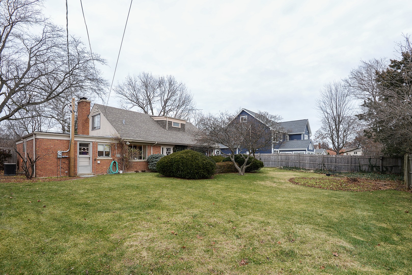 3225 Illinois Road Wilmette, IL 60091 - Photo 20 of 21 a view of a house with a big yard and large trees