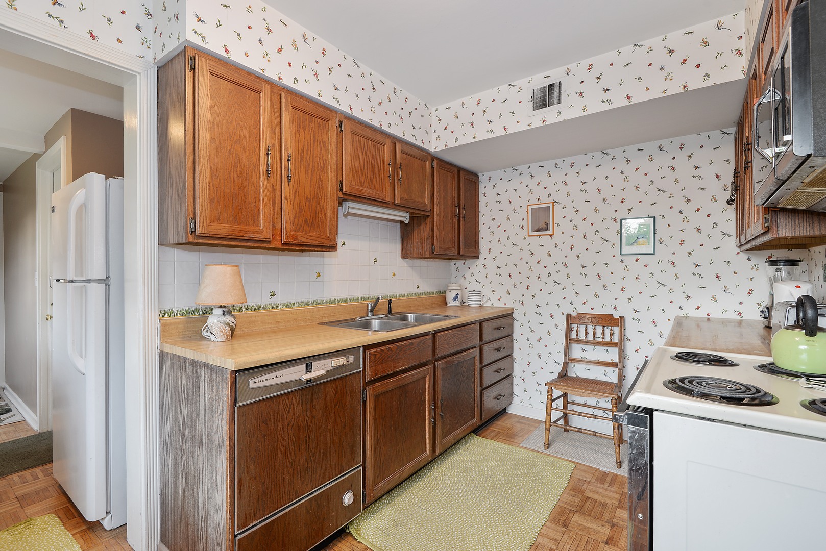 3225 Illinois Road Wilmette, IL 60091 - Photo 9 of 21 a kitchen with stainless steel appliances a stove a sink and a refrigerator