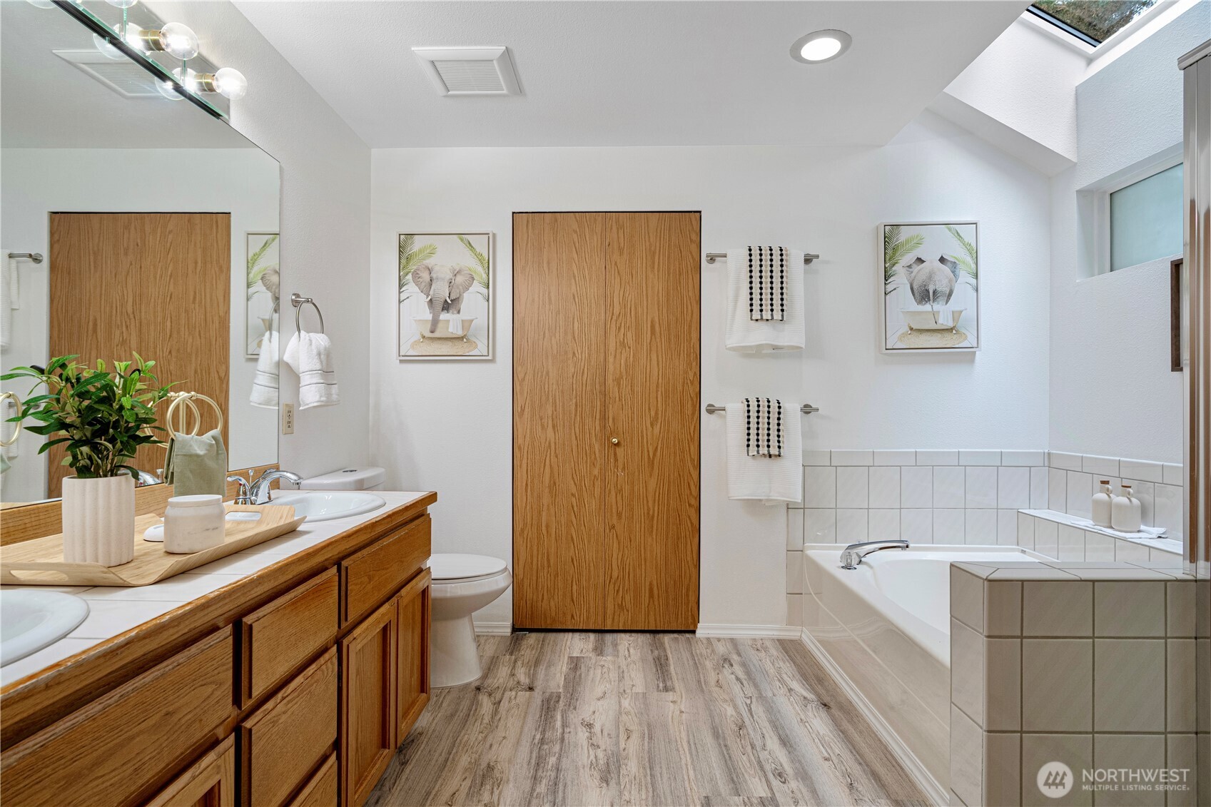 11719 Northeast 166th Court Bothell, WA 98011 - Photo 13 of 27 a bathroom with a sink a mirror and a bathtub