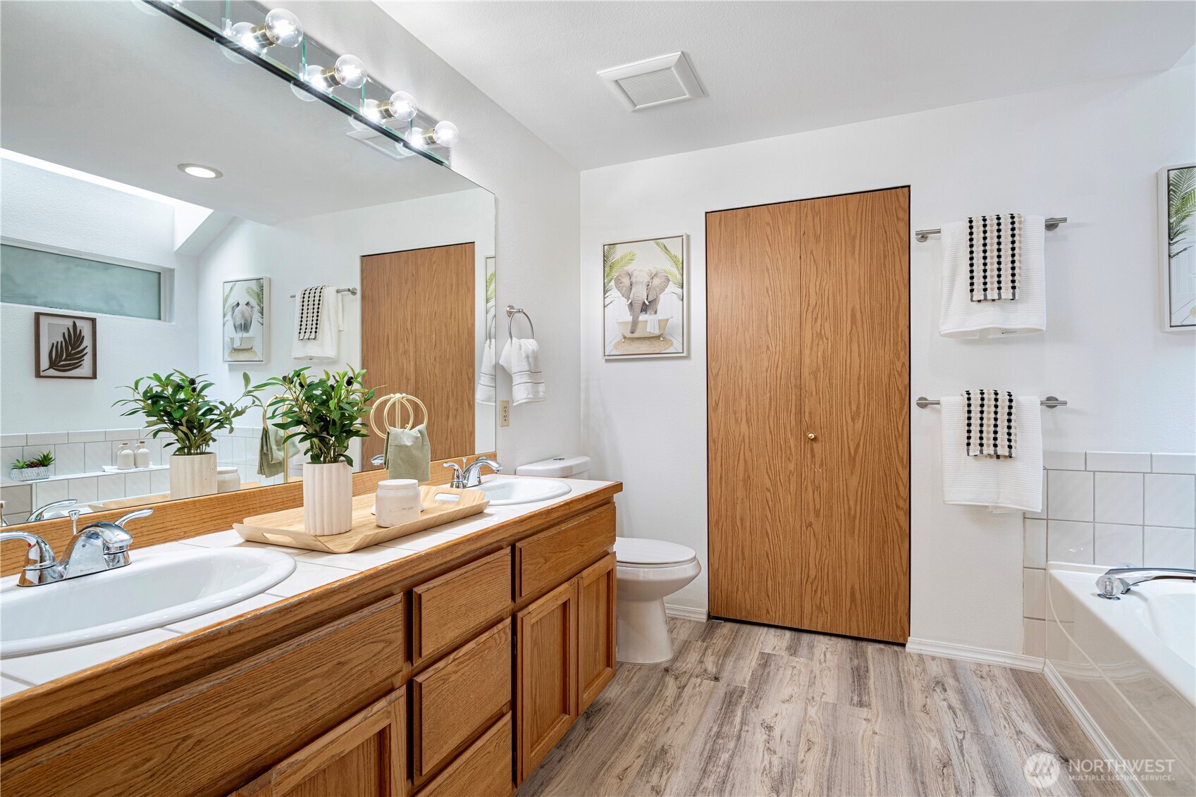11719 Northeast 166th Court Bothell, WA 98011 - Photo 14 of 27 a bathroom with a double vanity sink and a mirror