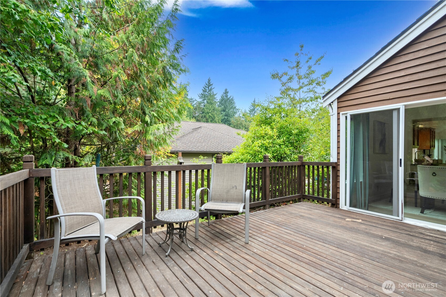 11719 Northeast 166th Court Bothell, WA 98011 - Photo 23 of 27 a view of a chair and table on the wooden deck