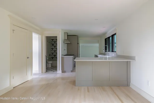 an empty room with closet and a bathroom