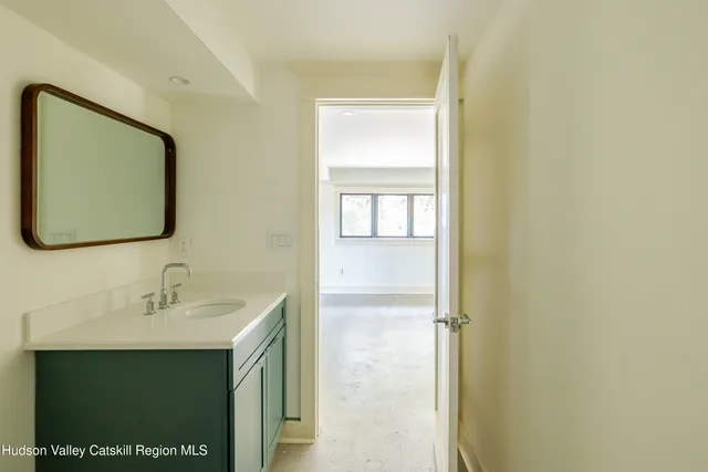 an empty room with windows and entrance