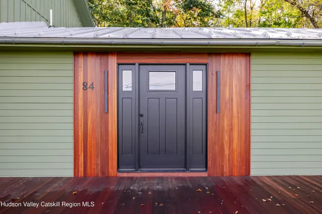 a view of a house with a big yard and a large tree