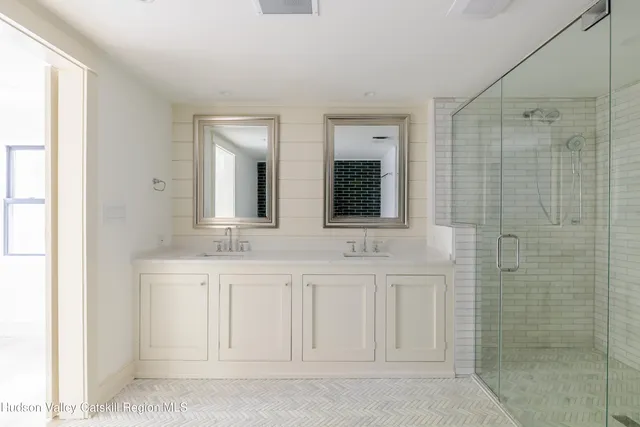 a bathroom with a sink a mirror and a shower