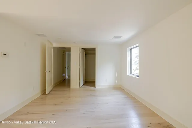 a picture of a room with a white wall and a painting