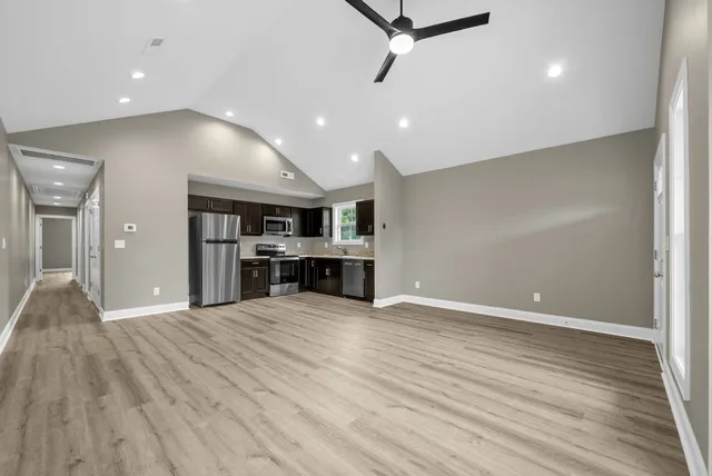 a view of a kitchen with a dishwasher and wooden floor