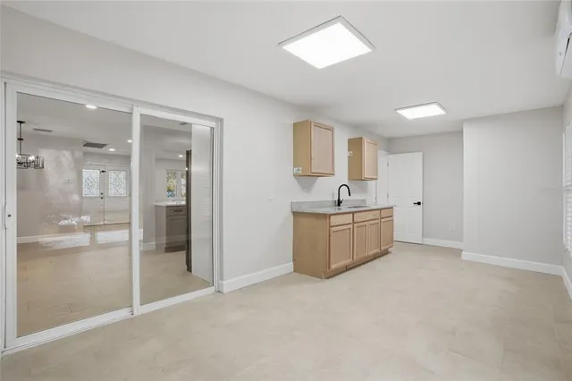 a view of a kitchen with a sink and a refrigerator