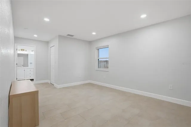 an empty room with a empty space and windows