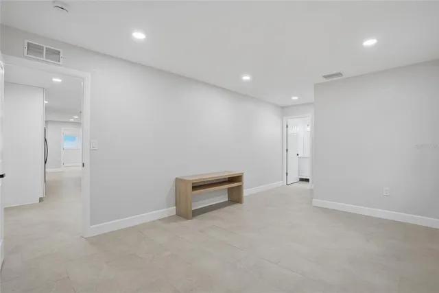 an empty room with furniture and a window