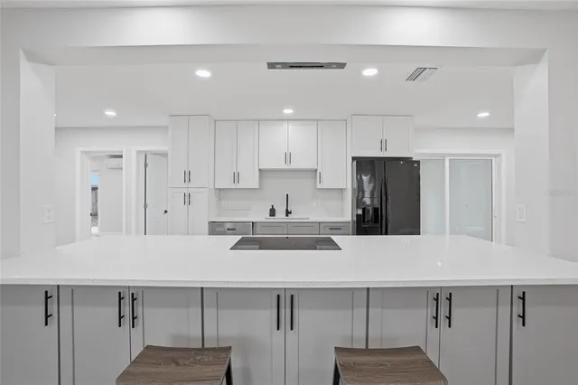 a kitchen with stainless steel appliances a sink and cabinets