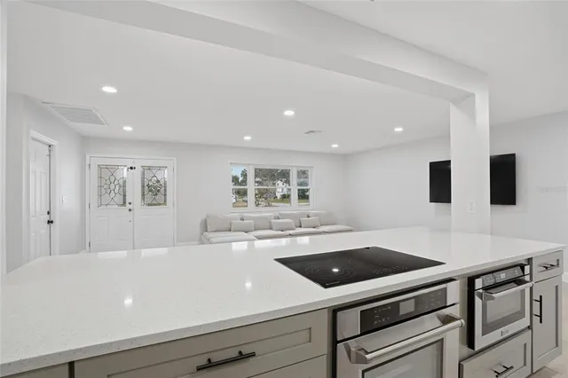 a view of a kitchen center island and stainless steel appliances