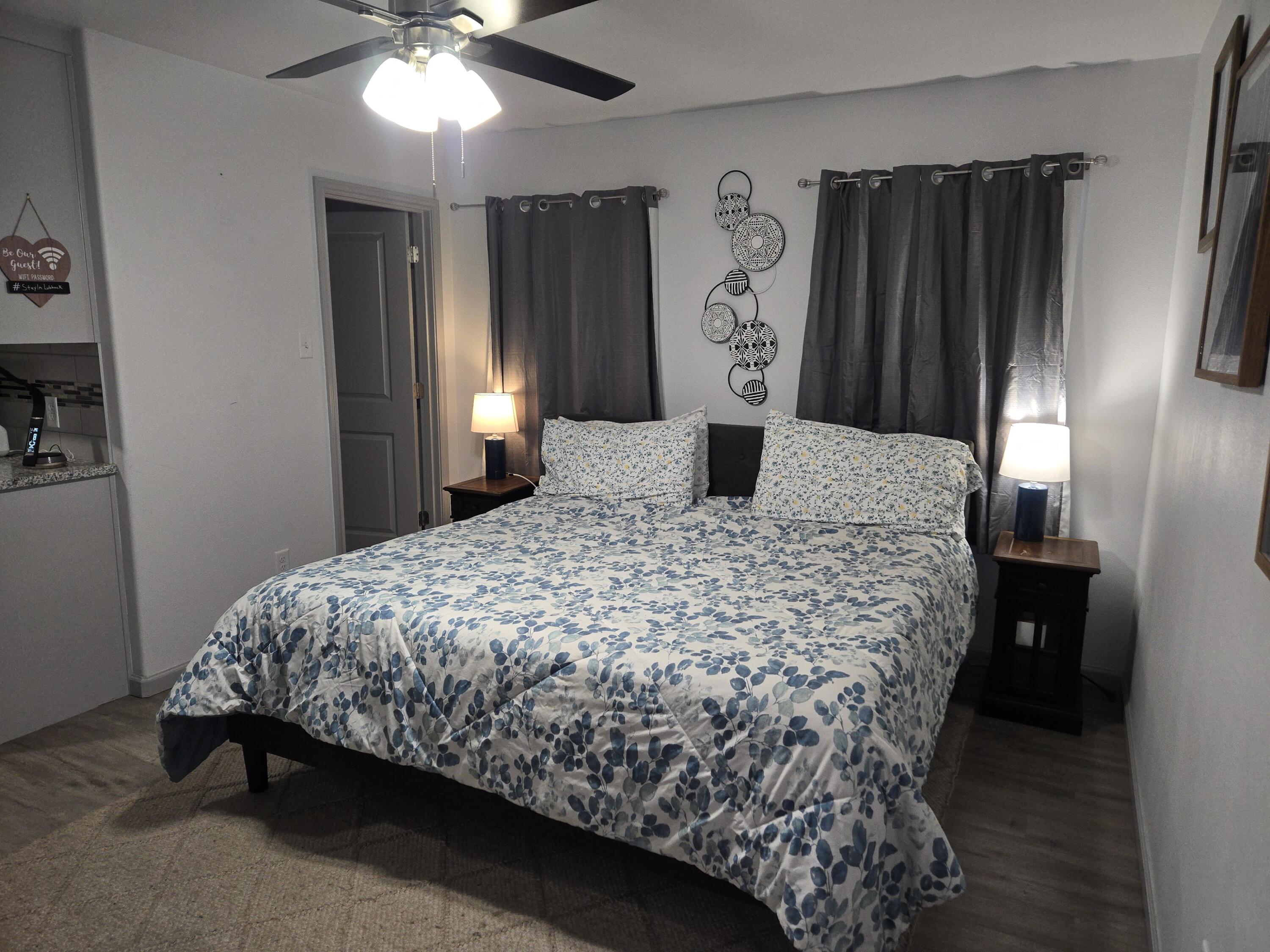 3809 36th Street, Unit A Lubbock, TX 79413 - Photo 1 of 9 a bed sitting in a bedroom next to a window and a chandelier