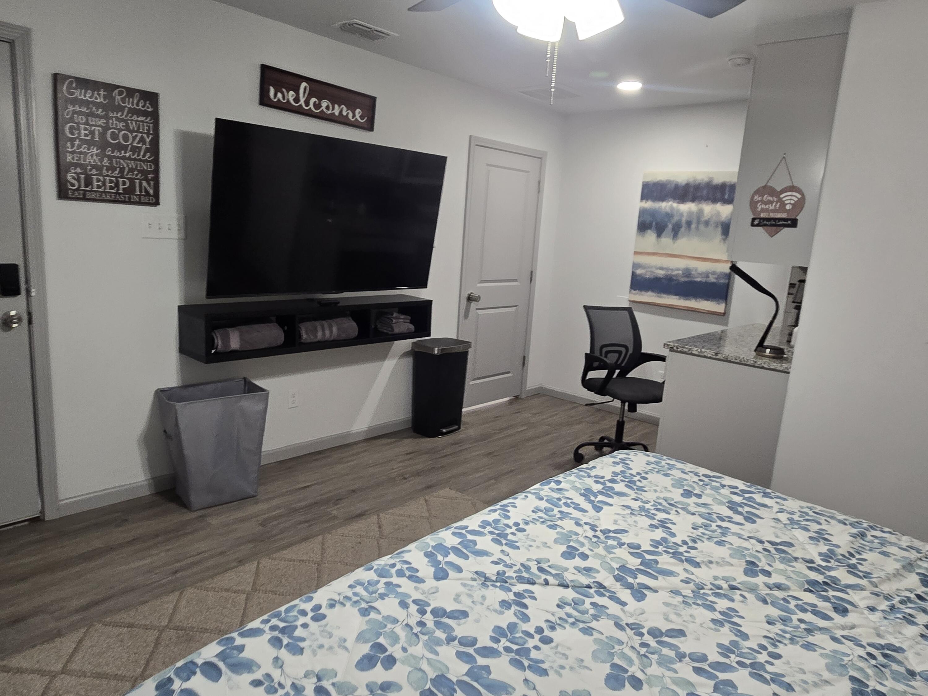 3809 36th Street, Unit A Lubbock, TX 79413 - Photo 3 of 9 a living room with furniture and a flat screen tv