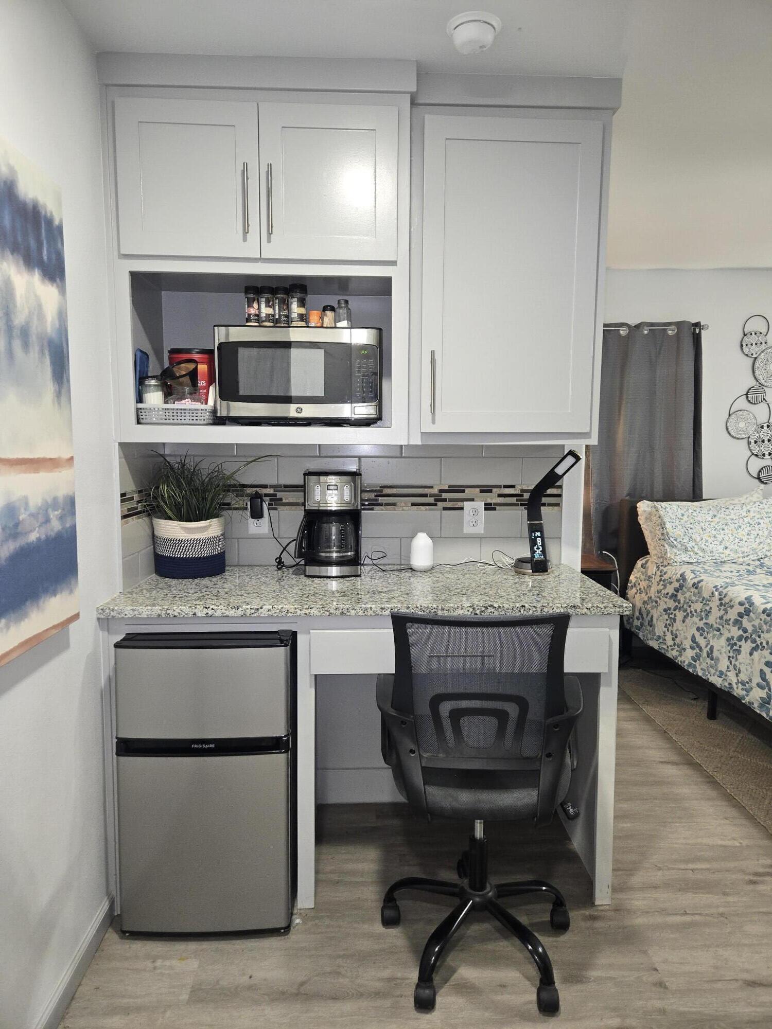 3809 36th Street, Unit A Lubbock, TX 79413 - Photo 5 of 9 a kitchen with stainless steel appliances granite countertop a stove and a sink