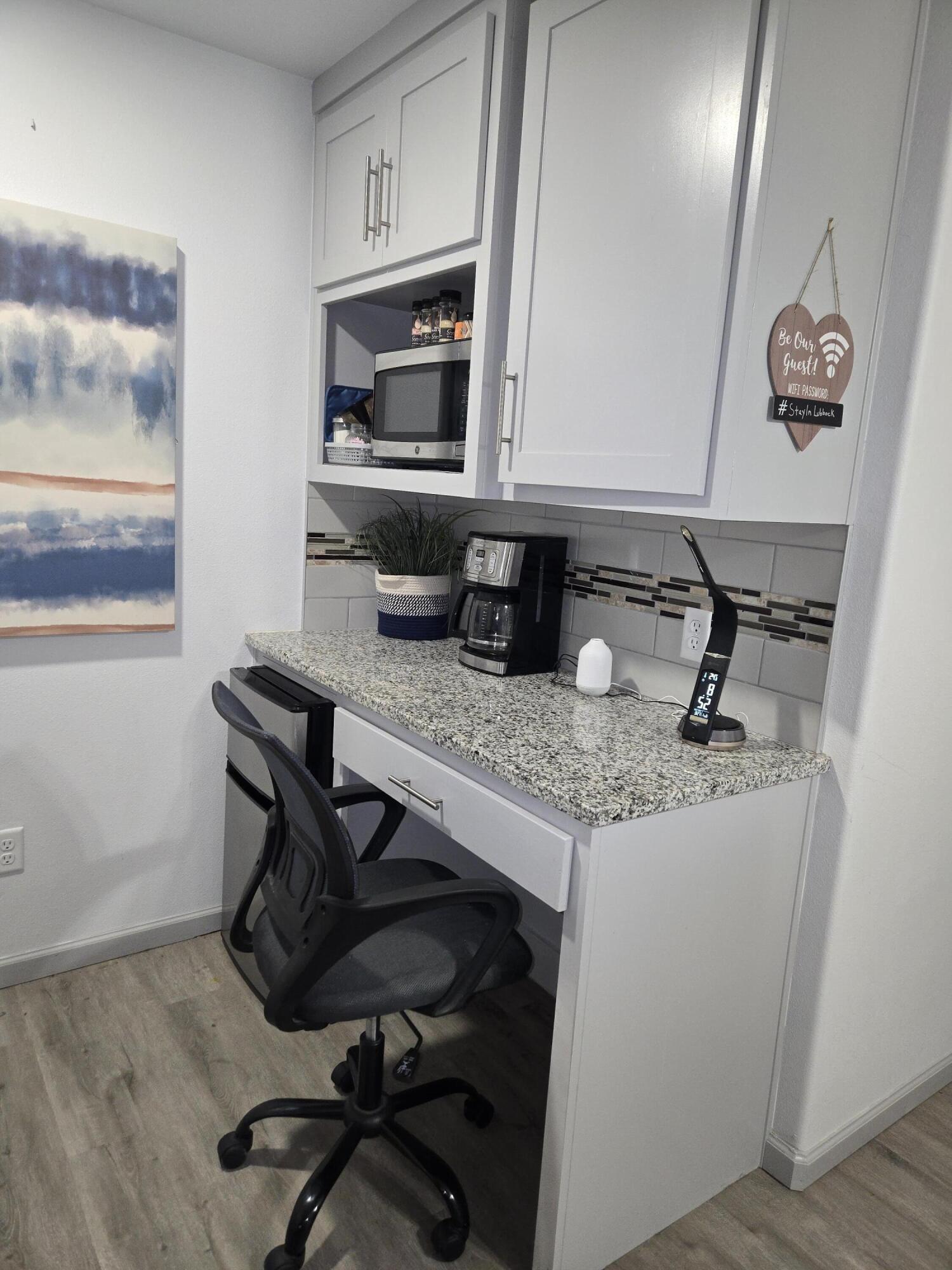 3809 36th Street, Unit A Lubbock, TX 79413 - Photo 6 of 9 a kitchen with a sink cabinets and wooden floor