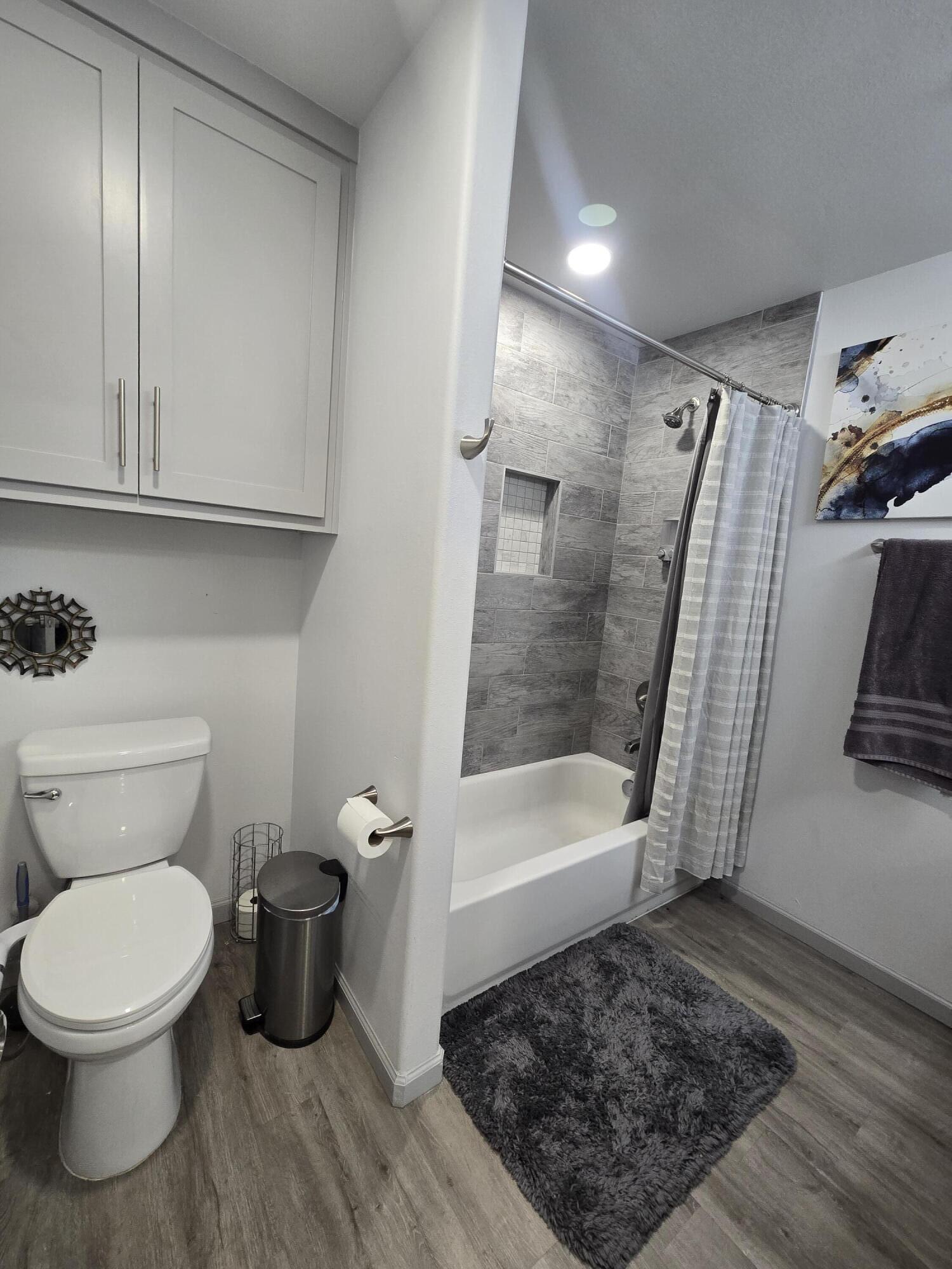3809 36th Street, Unit A Lubbock, TX 79413 - Photo 7 of 9 a bathroom with a toilet and a shower