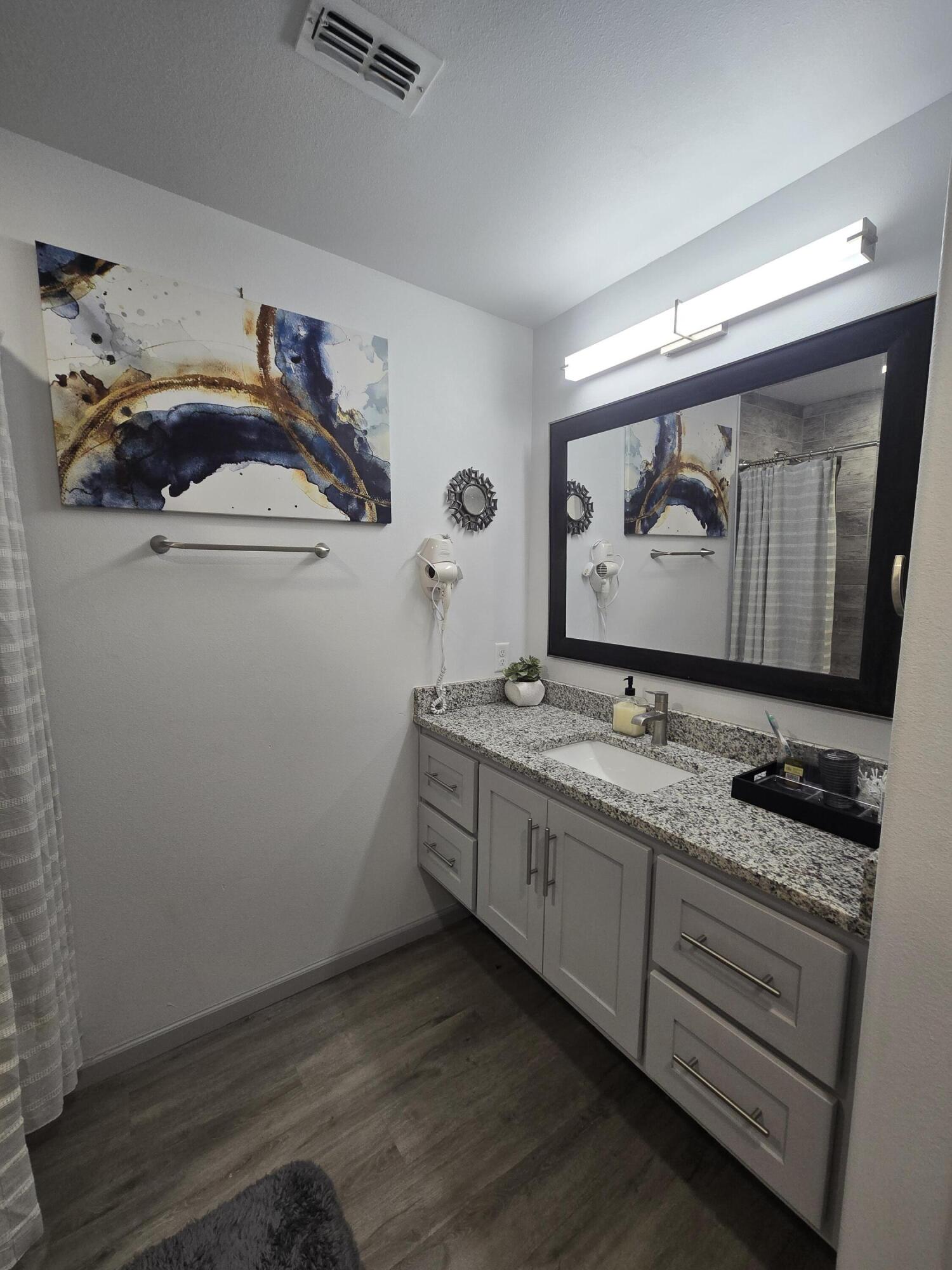 3809 36th Street, Unit A Lubbock, TX 79413 - Photo 8 of 9 a bathroom with a sink and mirror with toilet