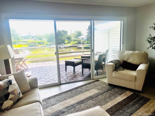 35 Library Avenue, Unit 6J Westhampton Beach, NY 11978 - Photo 14 of 19 Tiled living area with a water view