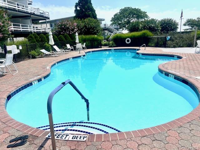 35 Library Avenue, Unit 6J Westhampton Beach, NY 11978 - Photo 17 of 19 Community pool with a patio