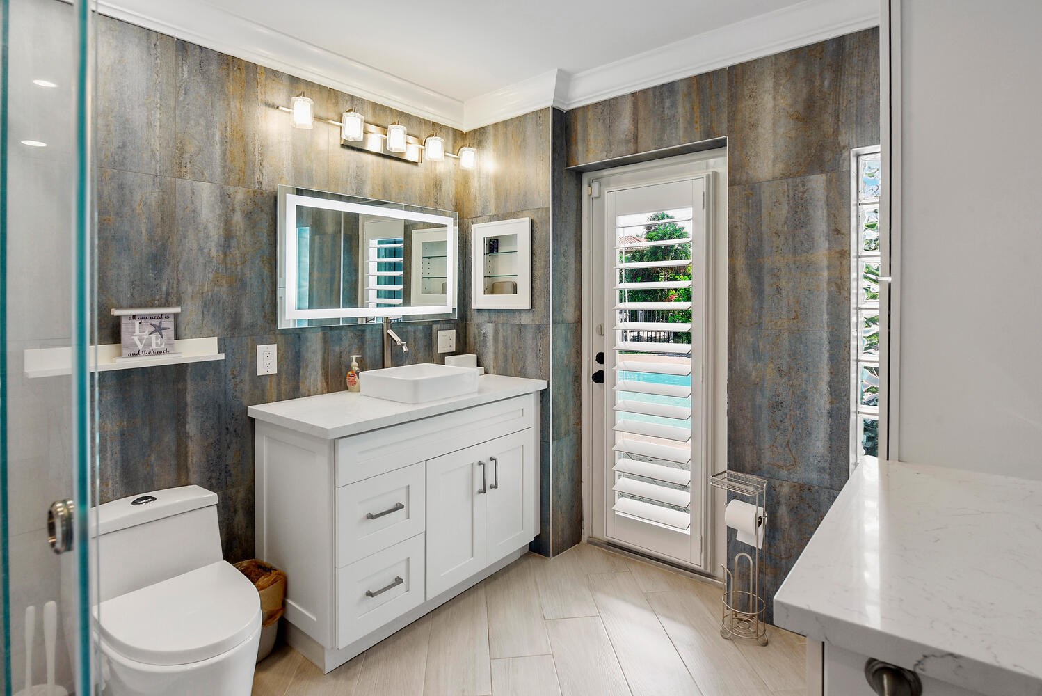 4030 Northeast 25th Avenue Lighthouse Point, FL 33064 - Photo 25 of 50 a bathroom with a sink a toilet and vanity