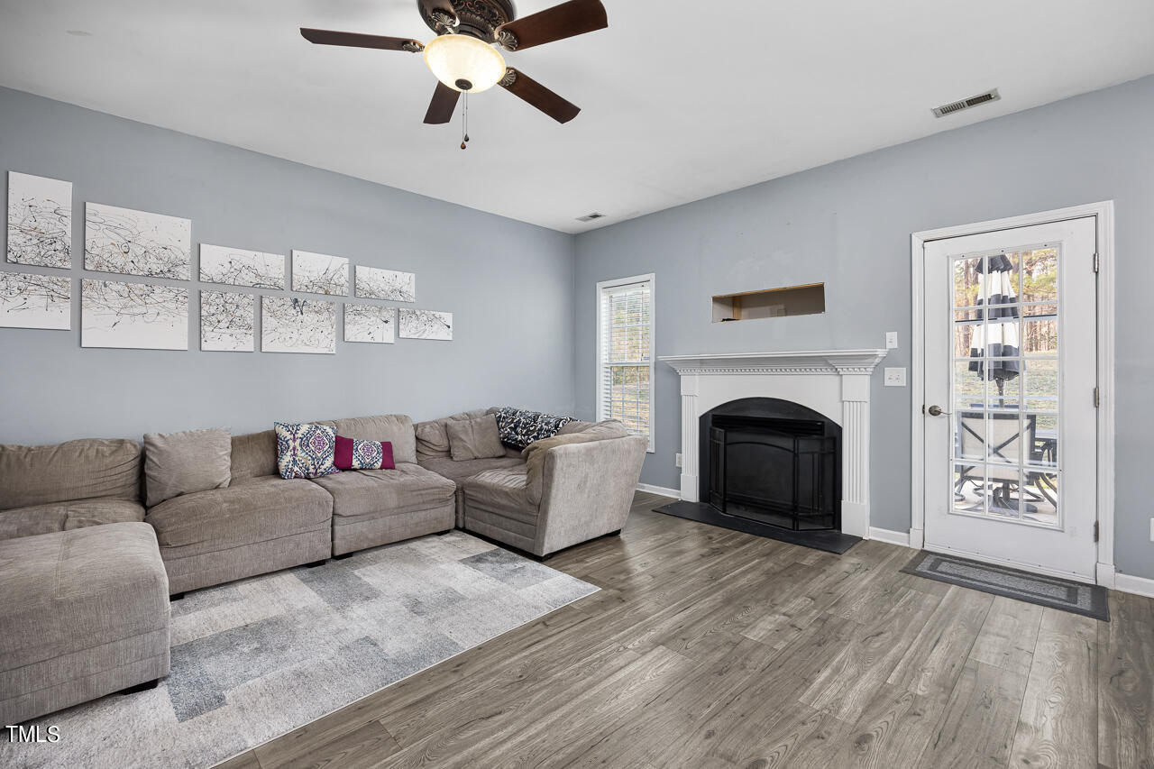 704 Nightshade Way Raleigh, NC 27610 - Photo 11 of 39 a living room with furniture and a fireplace