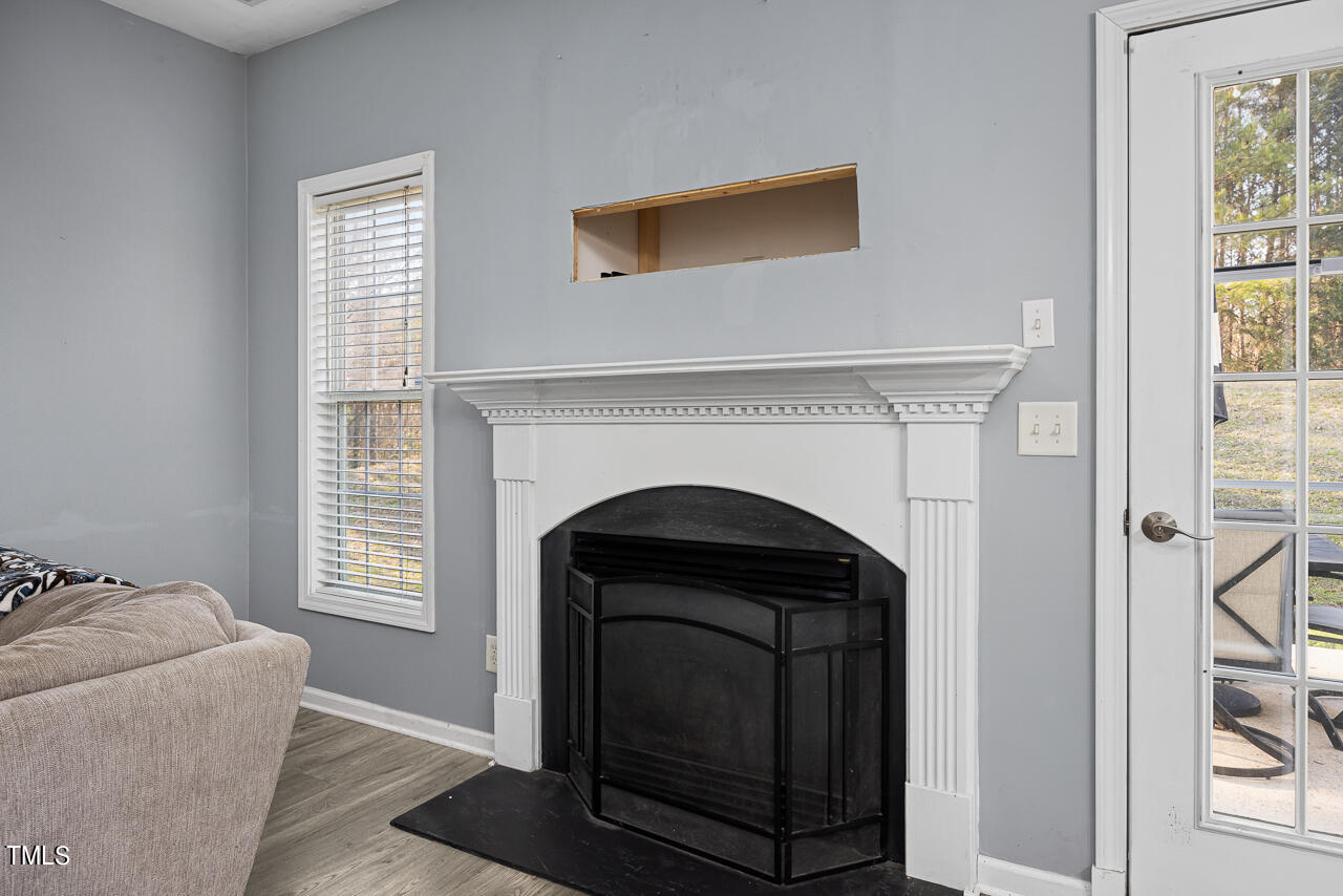 704 Nightshade Way Raleigh, NC 27610 - Photo 13 of 39 a living room with a fireplace and a window