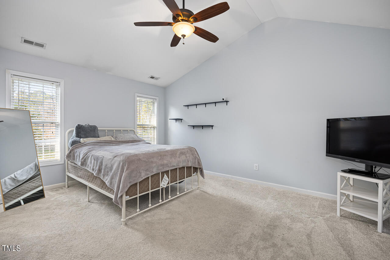 704 Nightshade Way Raleigh, NC 27610 - Photo 22 of 39 a bedroom with a bed and a flat screen tv