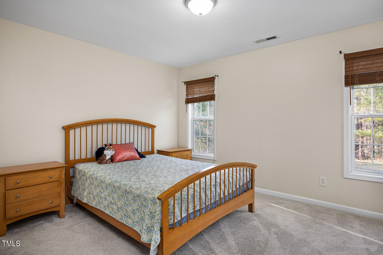704 Nightshade Way Raleigh, NC 27610 - Photo 27 of 39 a bedroom with a bed and a window