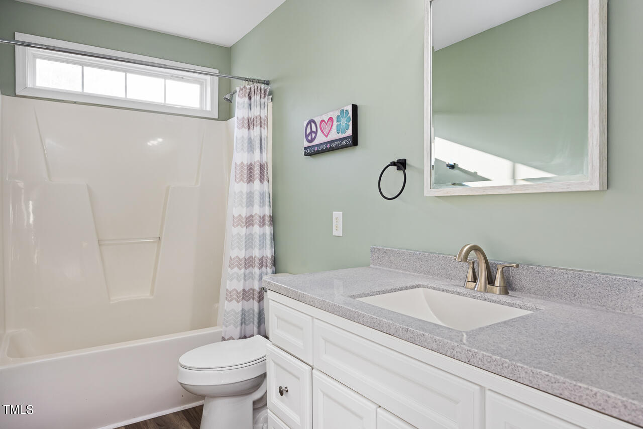 704 Nightshade Way Raleigh, NC 27610 - Photo 28 of 39 a bathroom with a granite countertop sink toilet and shower