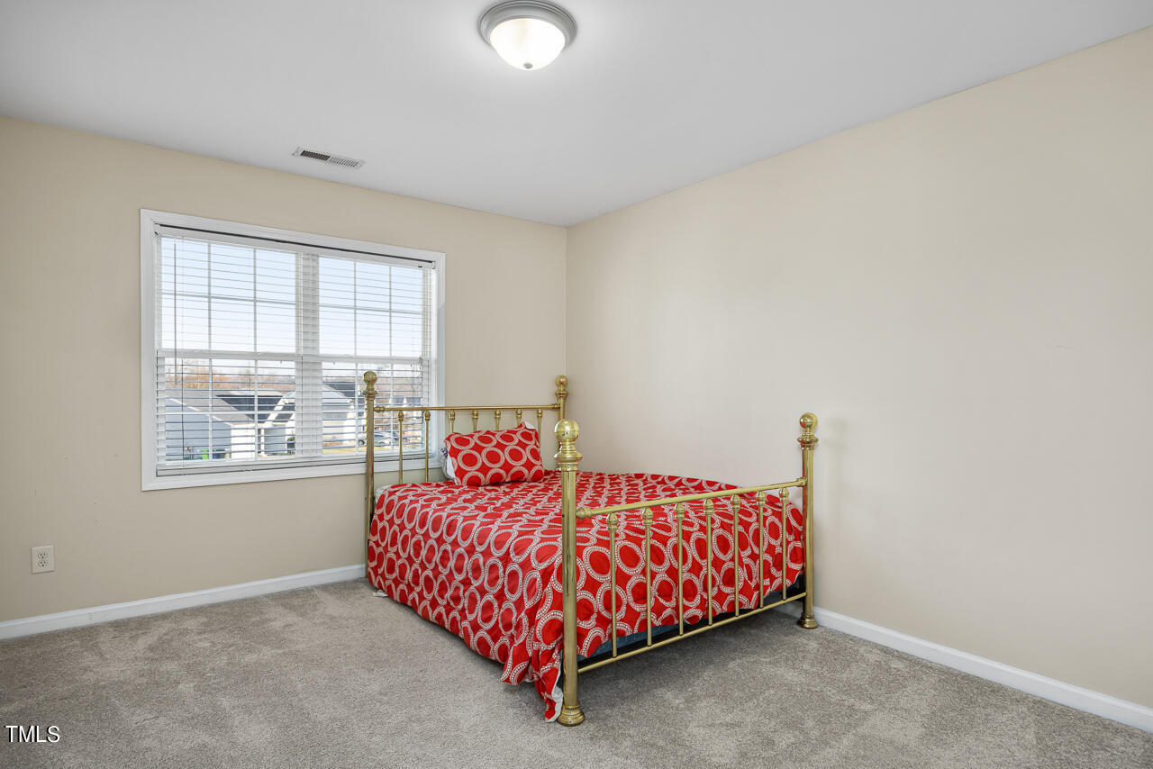 704 Nightshade Way Raleigh, NC 27610 - Photo 29 of 39 a bedroom with a bed and window