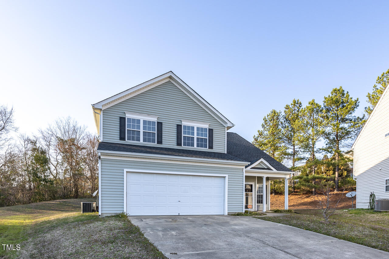704 Nightshade Way Raleigh, NC 27610 - Photo 3 of 39 a front view of a house with a yard and garage