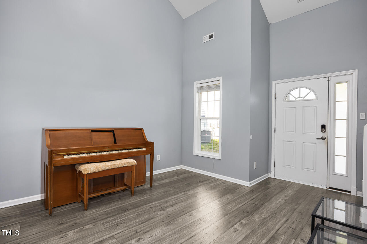 704 Nightshade Way Raleigh, NC 27610 - Photo 6 of 39 a room with a piano and wooden floor