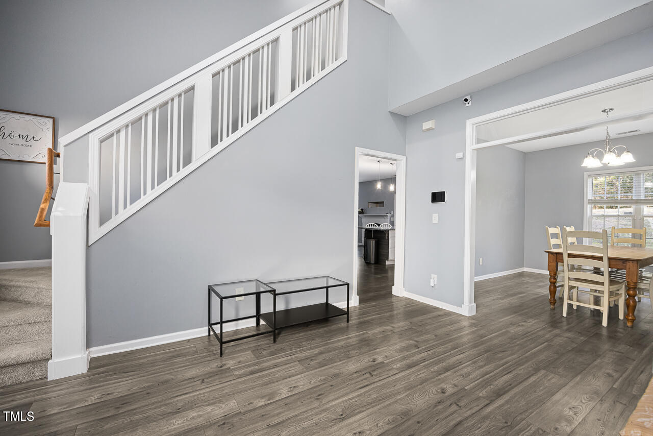 704 Nightshade Way Raleigh, NC 27610 - Photo 8 of 39 a view of a hallway with wooden floor and dining room