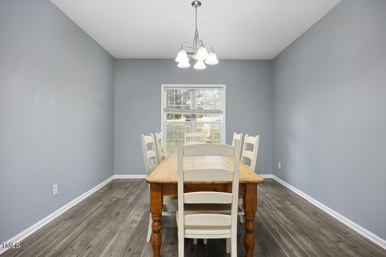 704 Nightshade Way Raleigh, NC 27610 - Photo 9 of 39 a view of a dining room with furniture window and wooden floor