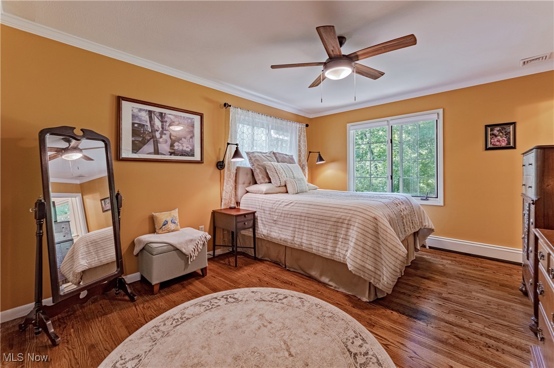8062 Chagrin Road Chagrin Falls, OH 44023 - Photo 30 of 50 Upstairs you immediately experience serenity when you enter the tastefully appointed Primary suite, boasting gleaming refinished hardwood floors and stunning views of the tranquil, park-like backyard.
