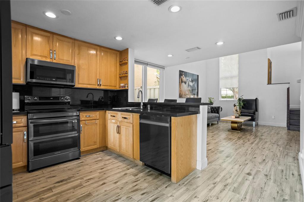 9837 Northwest 2nd Court Plantation, FL 33324 - Photo 12 of 69 a kitchen with a sink appliances and cabinets