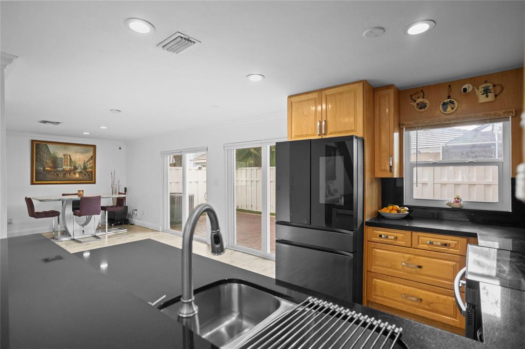 9837 Northwest 2nd Court Plantation, FL 33324 - Photo 14 of 69 a kitchen with stainless steel appliances granite countertop a refrigerator and a stove top oven