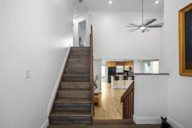 a view of staircase and kitchen with wooden floor