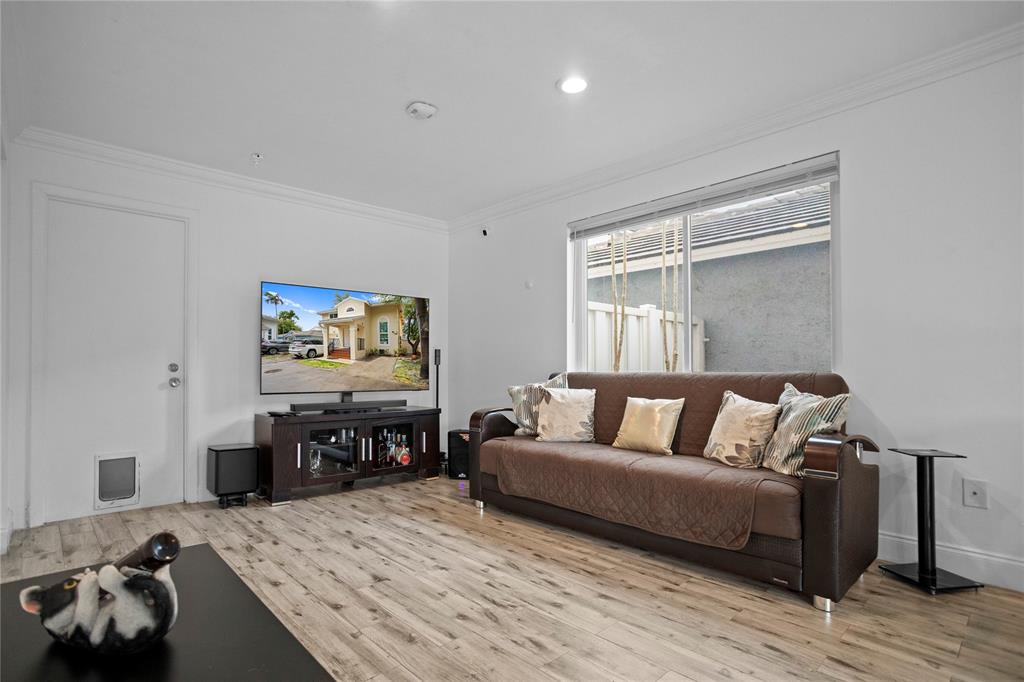 9837 Northwest 2nd Court Plantation, FL 33324 - Photo 24 of 69 a living room with furniture and a flat screen tv