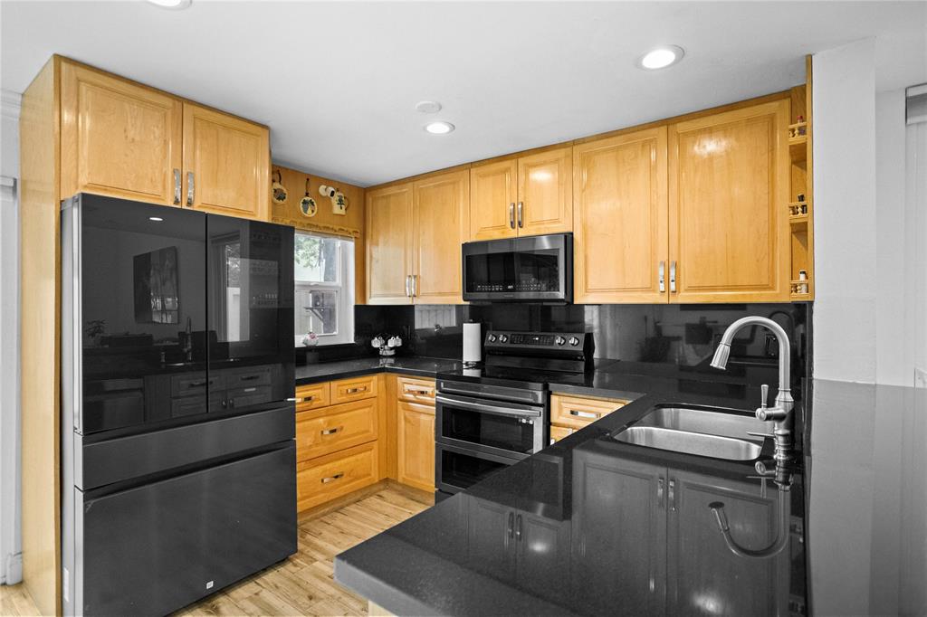 9837 Northwest 2nd Court Plantation, FL 33324 - Photo 34 of 69 a kitchen with stainless steel appliances granite countertop a refrigerator a stove top oven a sink and dishwasher