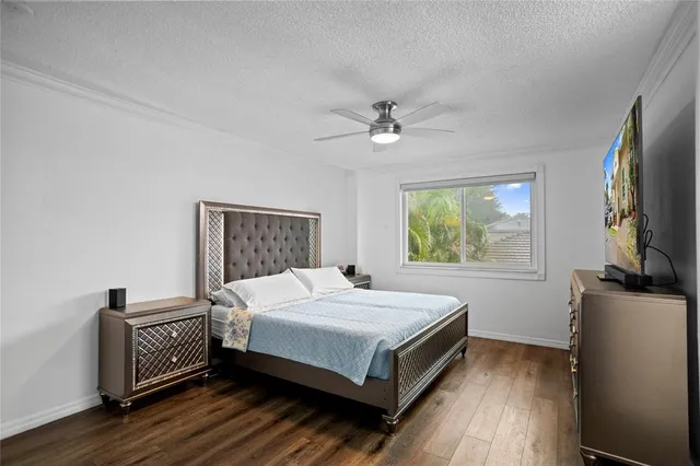 a bedroom with a bed and a potted plant