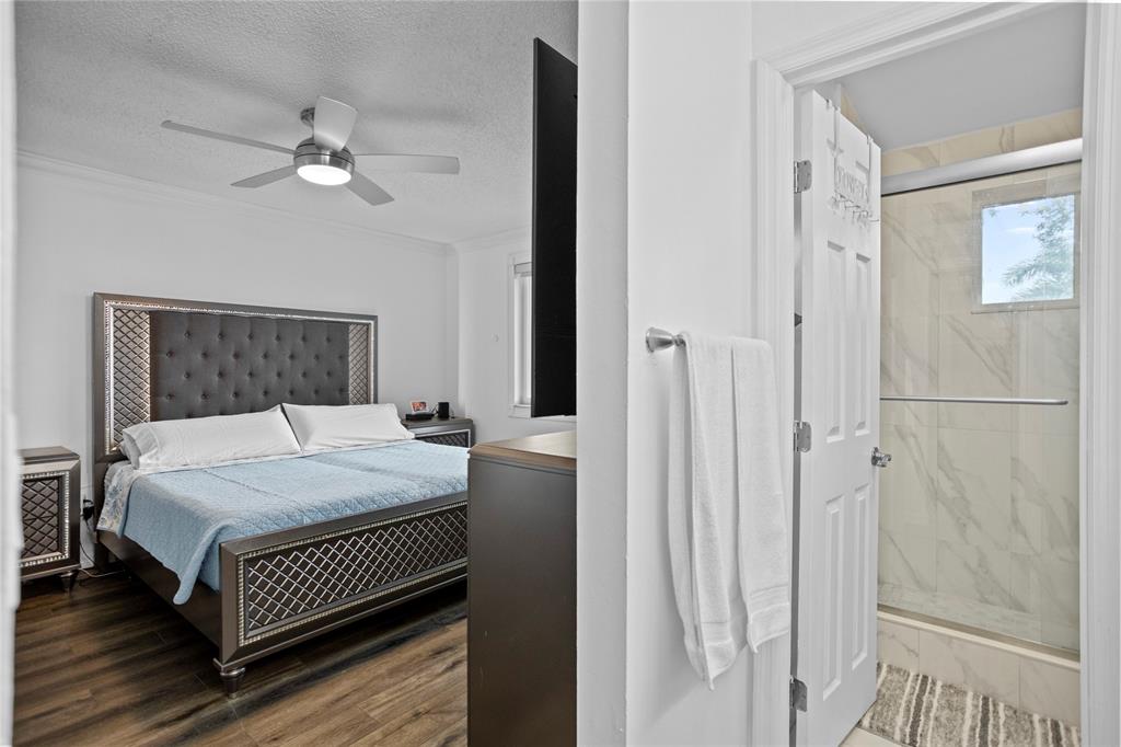 9837 Northwest 2nd Court Plantation, FL 33324 - Photo 46 of 69 a bedroom with a bed and a chandelier