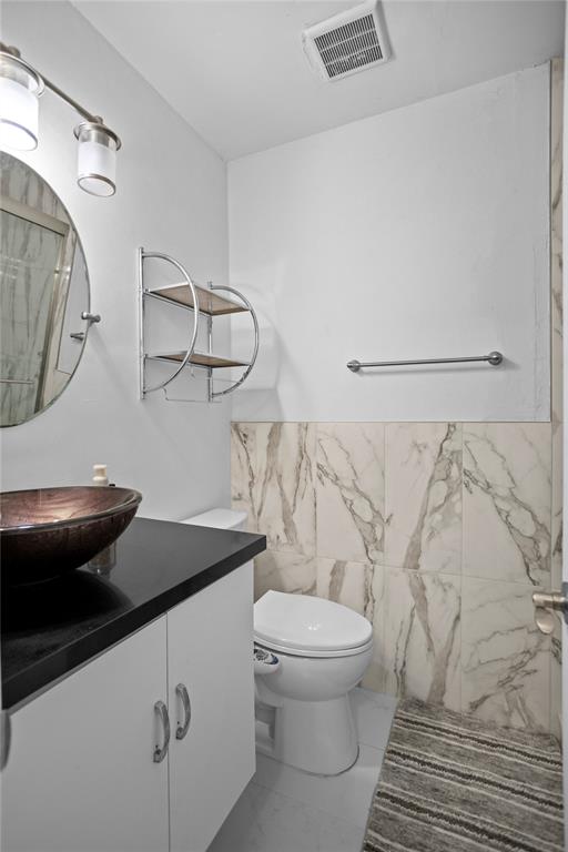 9837 Northwest 2nd Court Plantation, FL 33324 - Photo 52 of 69 a bathroom with a granite countertop sink a toilet and a mirror