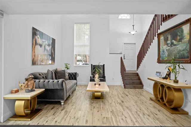 a kitchen with granite countertop a refrigerator and a stove top oven