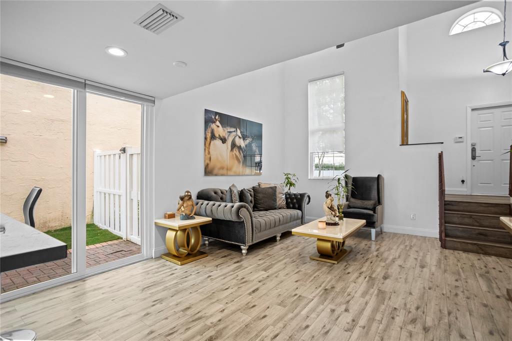 9837 Northwest 2nd Court Plantation, FL 33324 - Photo 9 of 69 a living room with furniture and a wooden floor