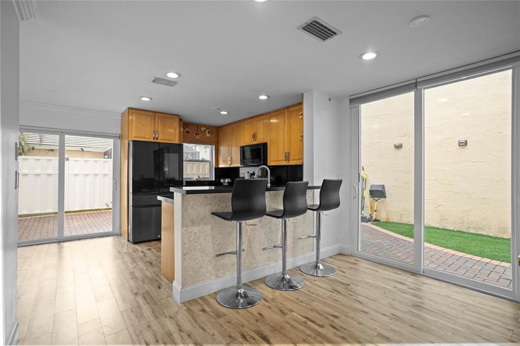 9837 Northwest 2nd Court Plantation, FL 33324 - Photo 10 of 69 a kitchen with stainless steel appliances kitchen island granite countertop a refrigerator and a stove top oven