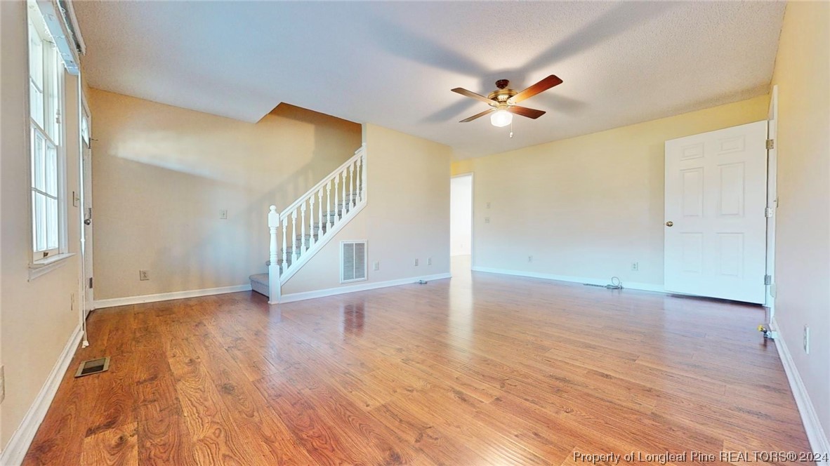 1132 North Moore Road Robbins, NC 27325 - Photo 4 of 50 a view of an empty room with wooden floor and a ceiling fan