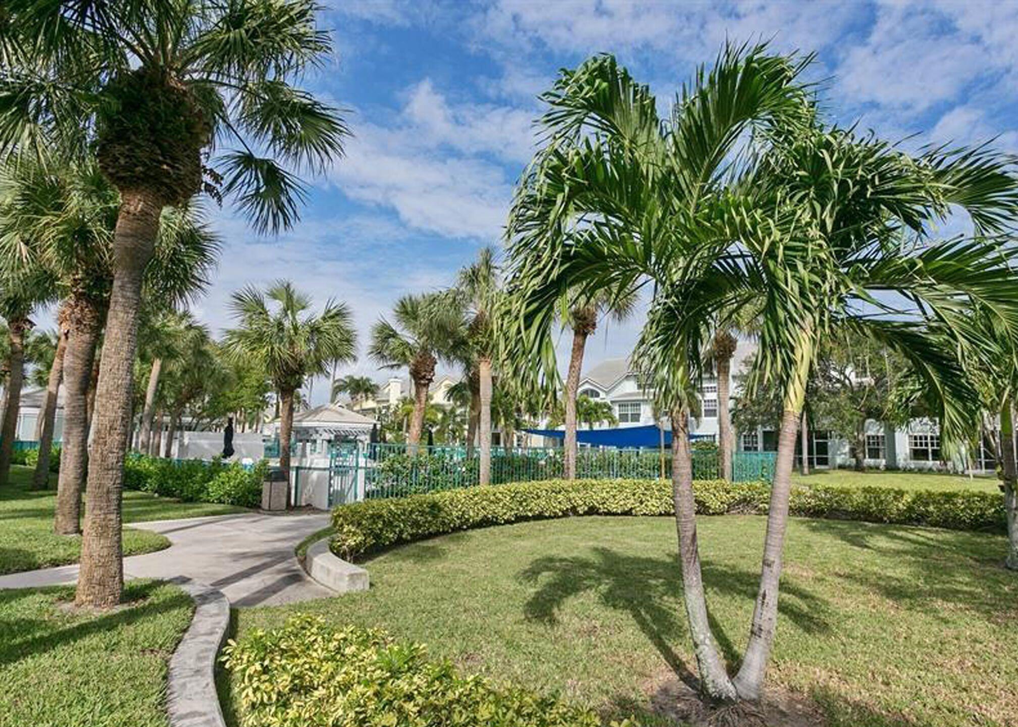3028 Windward Way Jupiter, FL 33477 - Photo 43 of 48 LushlyLandscapedPoolWalkway